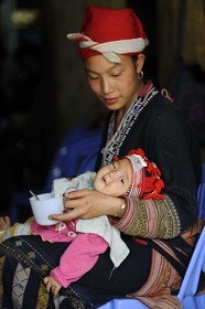 Vietnam, Lao Cai province, Sapa district, Ta Phin, Red Dzao ethnic minority young girl and baby