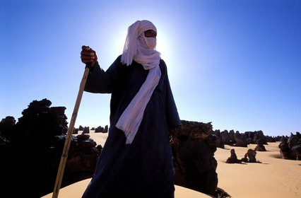 Libya, region of the desert, the Fezzan (Sahara), Tuareg walking between the needles of sandstone of Tassili of Maghidet (Algerian frontier)