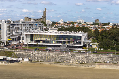 France, Charente-Maritime, Royan, the convention center (1957) designed by the architect-urban planner Claude Ferret and the Notre-Dame de Royan church built from 1955 to 1958 by the architect Guillaume Gillet in the background (aerial view)