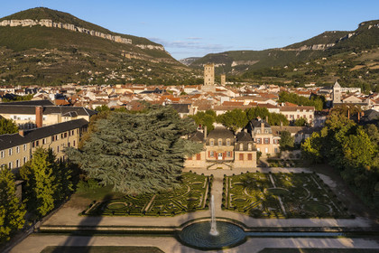 France, Aveyron, the Mansion of Sambucy De Sorgues and its French gardens, the belfry in the heart of the city and et the Puncho d'Agast mountain in the background (aerial view)