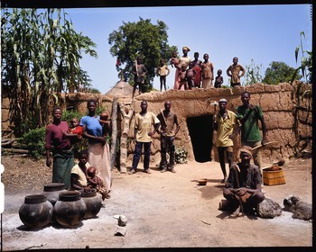 Burkina Faso, Poni province, Lobi land, Loropéni, peasants posing with hoe in the farmyard in front of the mainhouse