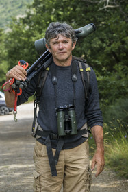 France, Drome, regional natural park of Baronnies provencales, Remuzat, Christian Tessier, director of the Vautours en Baronnies association, goes to observe griffon vultures on the Saint-Laurent plateau with a telescope over his shoulder