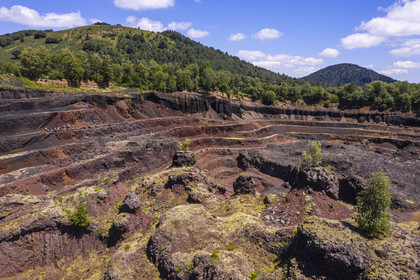 France, Puy de Dome, Parc Naturel Régional des Volcans d'Auvergne (regional nature park of Auvergne volcanoes), Chaine des Puys listed as World heritage by UNESCO, Saint Ours les Roches, Lemptegy volcano, a former pozzolan quarry that has become an educational site open to the public, Puy Chopine on the left and Puy Chaumont on the right in the background (aerial view)