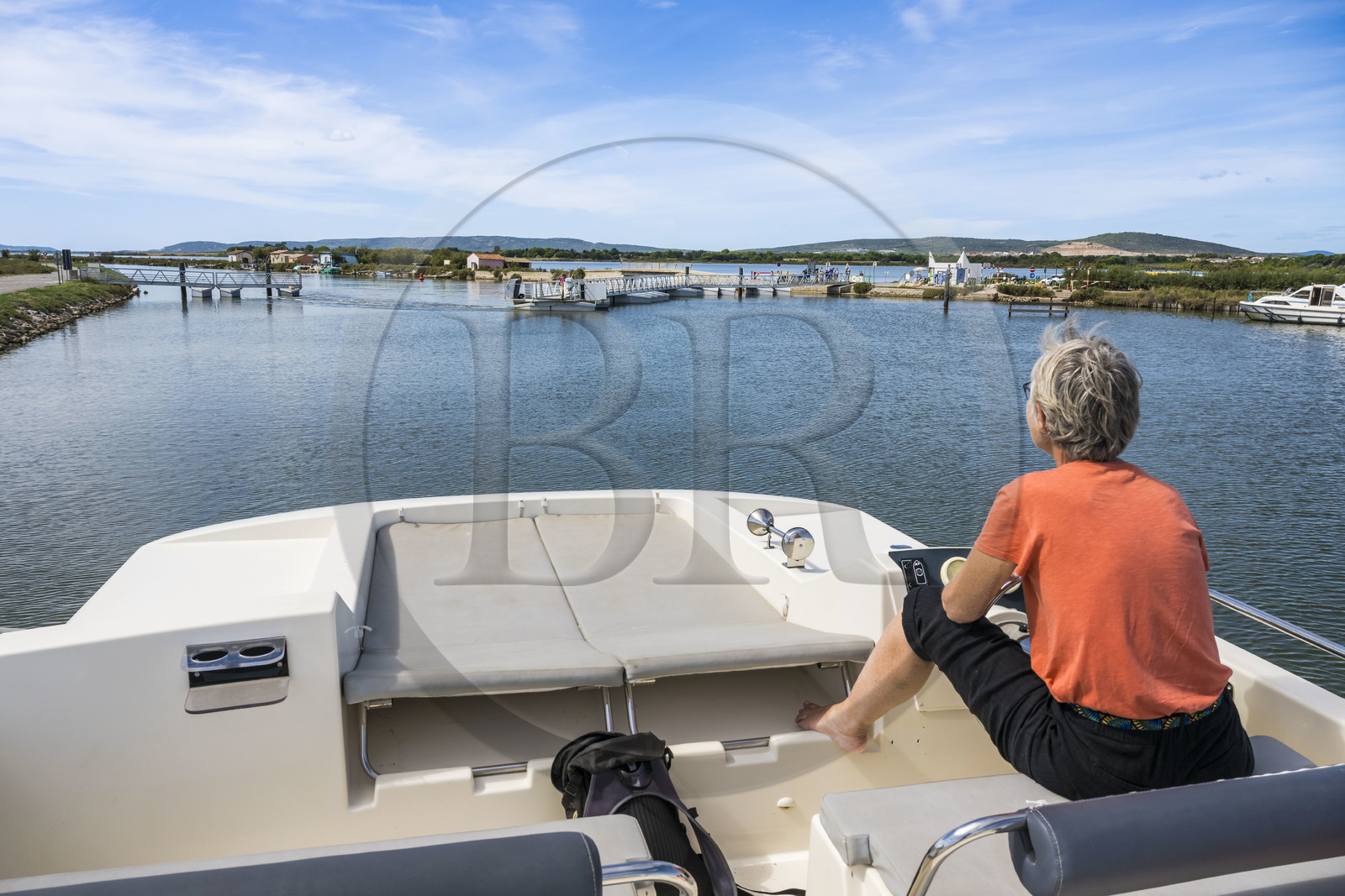France, Hérault (34), Villeneuve-lès-Maguelone, navigation d'un bateau de plaisance Le Boat sur le canal du Rhône à Sète en bordure de l'étang l'Arnel en arrière plan, ouverture de la Passerelle du Pilou mobile qui permet la traversée du canal