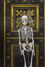 Switzerland, Basel, Old Basel, Augustinergasse, skeleton guarding the entrance to the Natural History Museum