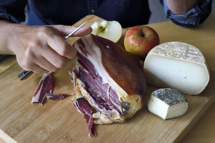 France, Corse du Sud, Prunelli river valley, Bastelica, Boutique Hotel Artemisia, its director Christophe Gandon taste a country ham together with local produce, apple, goat and sheep cheese