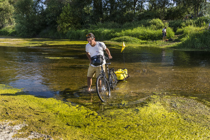 France, Maine-et-Loire, Loire valley listed as World Heritage by UNESCO, Saumur towards Saint-Hilaire, sandbanks forming islands on the Loire, cycling on the banks of the Loire, bike with a trailer carrying camping equipment