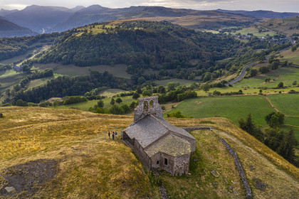 France, Cantal, Parc Naturel Régional des Volcans d'Auvergne (regional nature park of Auvergne volcanoes), Chastel-sur-Murat, 12th century perched on a promontory Saint Antoine (Saint Anthony) Chapel, hickers on the Way of St. James to Santiago de Compostela by Via Arverna (aerial view)