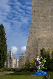 Portugal, Lisbon, Belem, Belem Cultural Centre MAC CCB, The Bathers (1985) by artist Niki de Saint-Phalle and the Jerónimos Monastery (Mosteiro dos Jerónimos), a UNESCO World Heritage Site, in the background