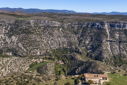 France, Herault, the Causses and the Cevennes, Mediterranean agro pastoral cultural landscape, listed as World Heritage by UNESCO, Saint Maurice Navacelles, Cirque de Navacelles, the rock of the Virgin is surrounded by a oxbow of the river La Vis, the Baume Auriol belvedere in the foreground (aerial view)