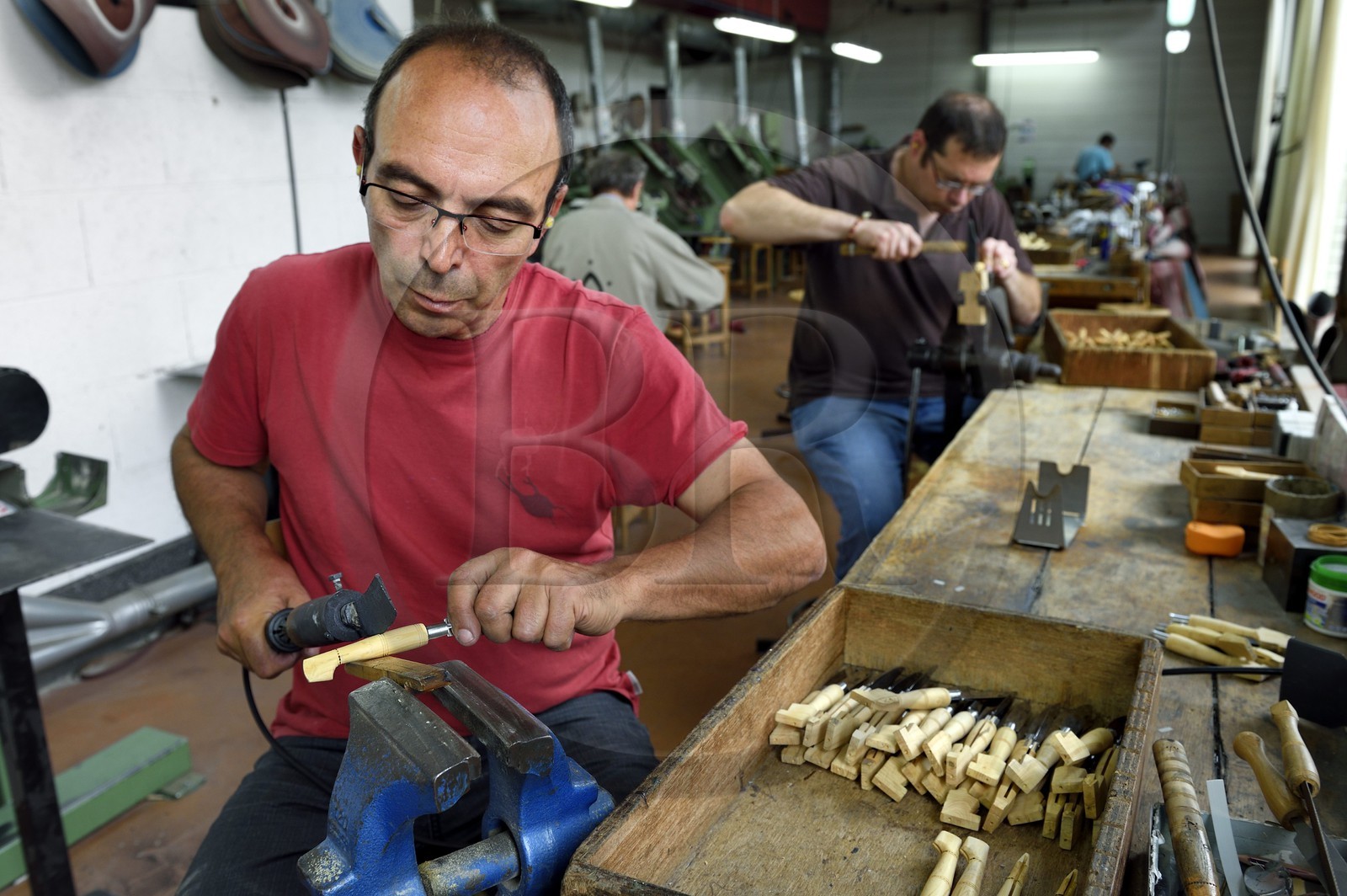 France, Dordogne, Périgord Vert, Nontron, manufacturing knives in the Coutellerie Nontronaise Factory, pattern of the handle pyrography