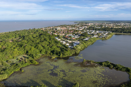 France, French Guiana, Kourou, the city is on the edge of wetlands, forests and savannas protected within the space center and managed by the National Forestry Office (ONF), bois-diable Lake to the right (aerial view)