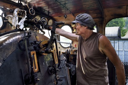 France, Alpes-Maritimes, Puget Theniers, steam engine warming up, in the cabin, Frederic Laugier volunteer of G.E.C.P. that restores and operates the Train des Pignes historic train, today fireman or stoker