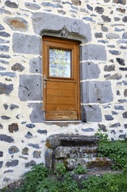 France, Cantal, Joursac, carved lintel of the house of a man who made the pilgrimage to Santiago de Compostela, we recognize the top of the bumblebee covered with a shell and the satchel which are symbols