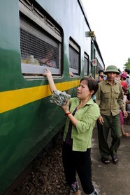 Vietnam, day train from Lao Cai to Hanoi, food selling at the stops