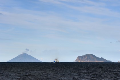 Italy, Sicily, Aeolian Islands, listed as World Heritage by UNESCO, ferry connecting the islands, Panarea Island right and the Stromboli volcano in the background