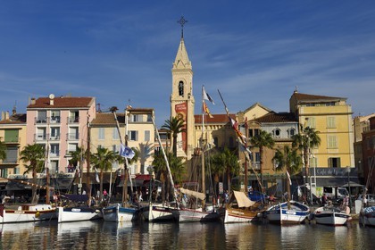 France, Var, Sanary-sur-Mer, traditional fishing boats called pointus in the port and St. Nazaire Church