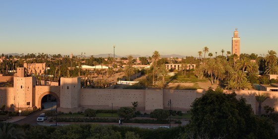 Morocco, High Atlas, Marrakech, Imperial city, Medina listed as World Heritage by UNESCO, the ramparts of the city and the minaret of the Koutoubia mosque in the background