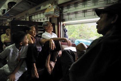 Vietnam, day train from Lao Cai to Hanoi, class Sat hard without climatisation, Wire nettings are there to protect the passengers of children's possible stones throw