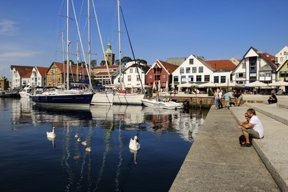 Norway, Rogaland County, Stavanger, pleasure boats and swans in the old harbour (Vagen)