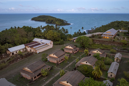 France, French Guiana, Kourou, Salvation Islands (Iles du Salut), Royal Island, which housed the administration, chapel and hospital of the penal colony, as well as the family accommodations of the guards in the foreground, Devil's Island in the background (aerial view)