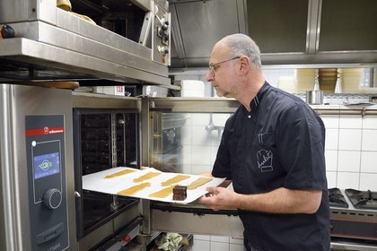 France, Meurthe-et-Moselle, Nancy, the pastry chef Didier Hulot making the gingerbread for Saint Nicholas Day, the dough is baked