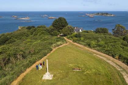 France, Cotes d'Armor, Ploubazlanec, the Widows' Cross, chapel and Pointe de la Trinité, in the background the Island of Saint-Riom and the multiple rocks that surround it (aerial view)