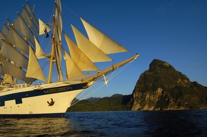 Caribbean sea, St Lucia island, the five masted ship SPV Royal Clipper with every sail set in front of the Piton of Soufriere