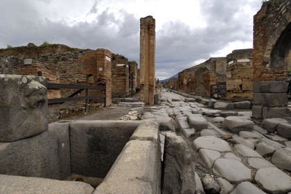 Italy, Campania, Pompei, archeological site listed as World Heritage by UNESCO, old paved street of the city and fountain
