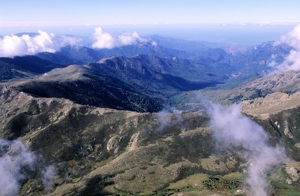 France, Corse du Sud, mountains of Corsica coming out of the clouds (aerial view)