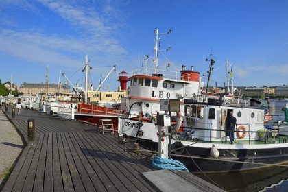 Sweden, Stockholm, island of Skeppsholmen, old boats moored at Östra Brobänken