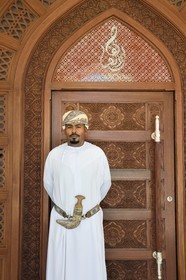 Sultanate of Oman, Muscat, Shati Al Qurm district, Opera Galleria, Royal Opera of Muscat luxurious shopping center, Al Angham restaurant, man wearing dishdasha (long tunic) with Omani khanjar (dagger) and turban called massar