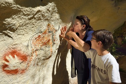 France, Dordogne, Vezere Valley, Sergeac, Prehistoric site of Castel Merle, reconstitution of prehistoric paintings gestures with jets of pigments