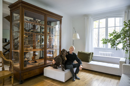 France, Paris, cartoonist and comic book author François Schuiten in his Parisian studio, with his dog Ulysses