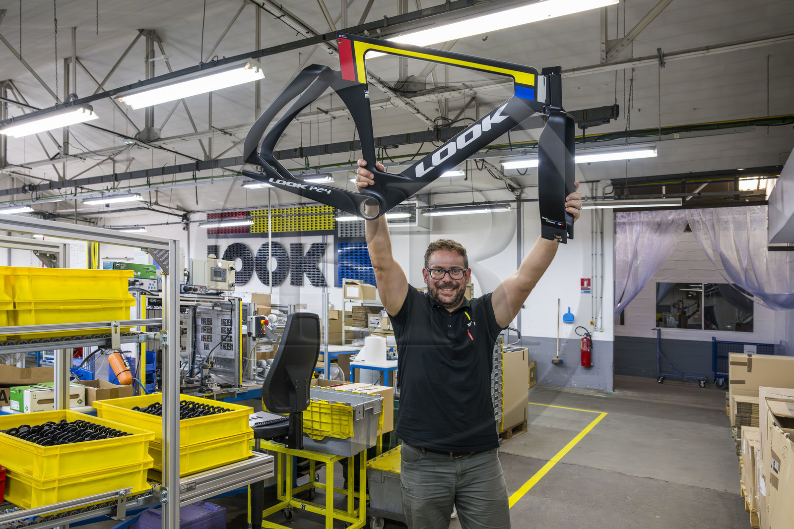 France, Nièvre (58), Nevers, entreprise Look Cycles International, le technicien site évenementiel Thomas Millot brandit le cadre du vélo de compétition en carbone ultra-léger LOOK P24 qui a permis à Benjamin Thomas de gagner la médaille d'or aux JO de Paris 2024