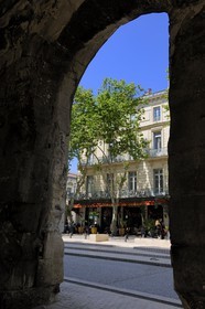France, Gard, Nimes, brasserie on the boulevard of the arenas through an arcade of the  arenas