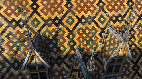France, Cote d'Or, Beaune, area listed as World Heritage by UNESCO, Hospices de Beaune, Hotel Dieu, the roofs covered with glazed and colored tiles (aerial view)