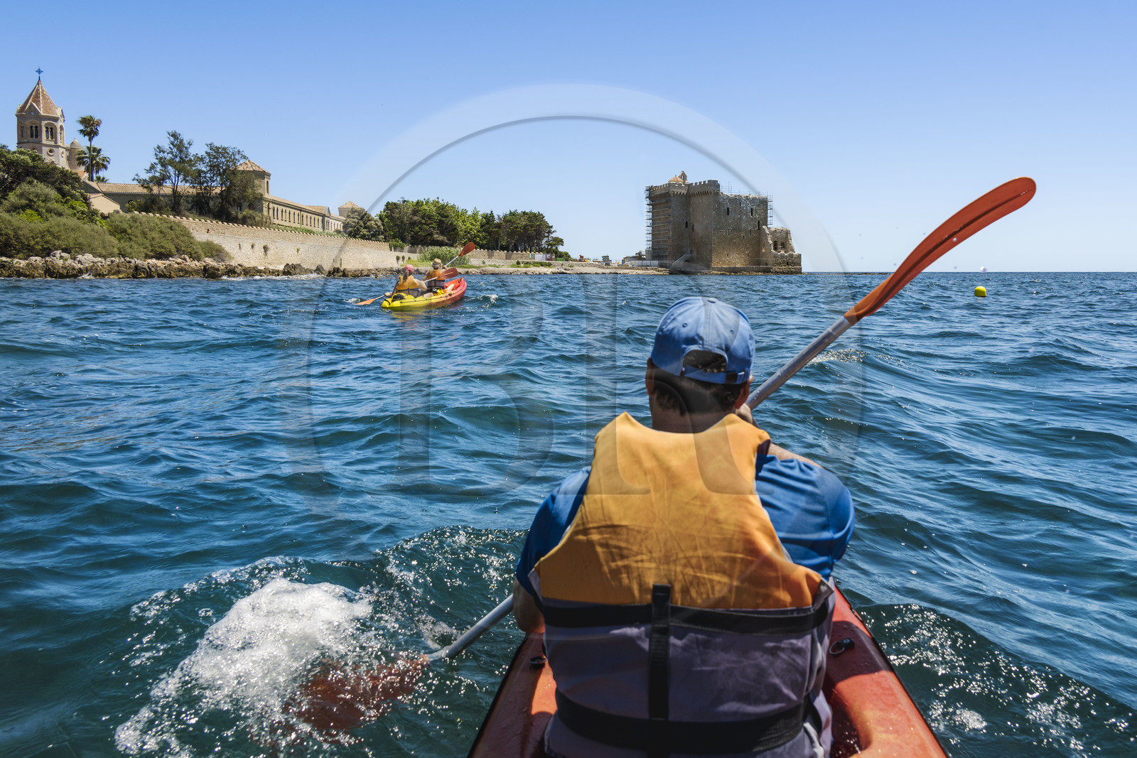 France, Alpes-Maritimes, Cannes, kayaking in the Lerins Islands, tour of the Saint-Honorat island from the south, the church of the Abbey of Lérins and the old fortified monastery in the background France, Alpes-Maritimes, Cannes, kayaking in the Lerins Islands, tour of the Saint-Honorat island from the south, the church of the Abbey of Lérins and the old fortified monastery in the background