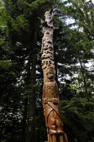 France, Vosges, chemin des passeurs (path used by border escorts) of Donon on the trail of escape connection of Rehtal, totem carved in the village by a group of youth in social rehabilitation, skull and crossbones represent the war and a vine represent the life which goes on