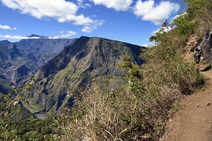 France, Reunion island (French overseas department), Reunion National Park listed as World heritage by UNESCO, La Possession, around village of Dos d'Ane, Roche Bouteille hike, hiker on the Cap Noir trail and the Cirque de Mafate on the left