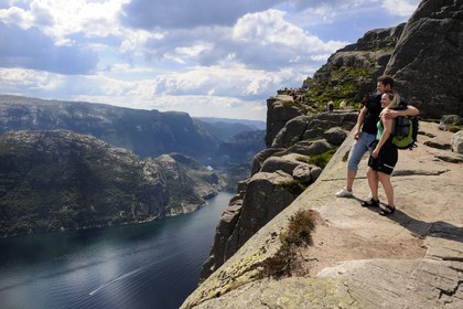 Norway, Rogaland County, Lysebotn Fjord, hikers in Preikestolen Rock at 600m above the Lysefjord