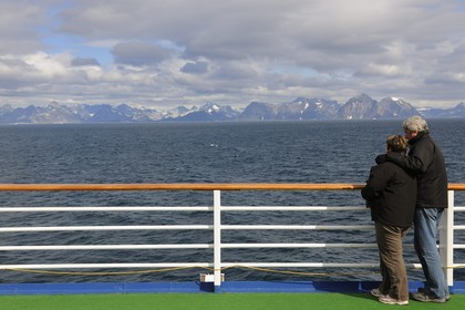 Greenland, Southern Region, cruise ship Princess Danae passing of Farvel (Farewell) Cape, couple watching the coast