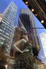 United States, New York, Manhattan, Midtown, 5th Avenue, the Trump Tower is reflected in the window of Henri Bendel fashion store