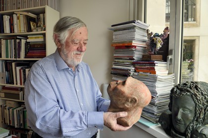 France, Paris, the french paleontologist and paleoanthropologist Yves Coppens, professor at the College de France, in the office of his home in Paris, he holds in his hand the supposed reproduction of Lucy's face