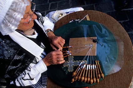 Belgium, West Flanders, Bruges (Brugge), one of the last lacemakers of the city on her work