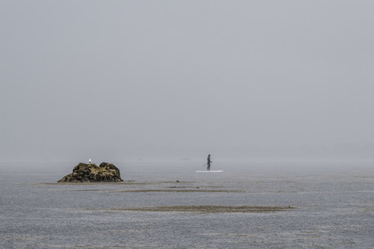 France, Finistère, Penmarch, Étocs archipelago, stand up paddle in the rain