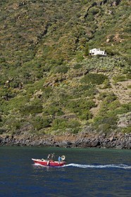 Italy, Sicily, Aeolian Islands, listed as World Heritage by UNESCO, Salina Island, fisherman in his boat returning to the port of Rinella
