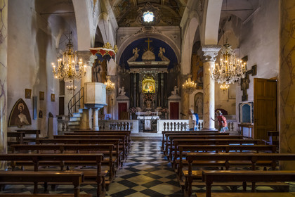 Italy, Liguria, Cinque Terre National Park listed as World Heritage by UNESCO, hikers in the church of the sanctuary of Nostra Signora di Reggio on the heights of the village of Vernazza