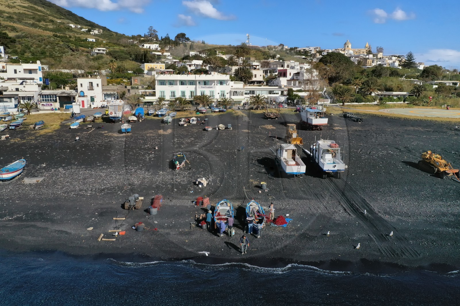 Italie, Sicile, iles Eoliennes, classées Patrimoine Mondial de l'UNESCO, ile de Stromboli, pecheurs sur la plage de Scari et le village de Stromboli en arrière plan (vue aérienne)