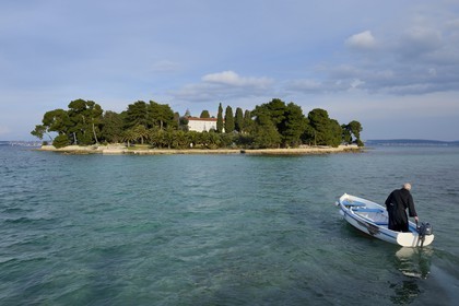 Croatia, Dalmatia, Dalmatian Coast, Ugljan Island, Preko, Franciscan friar Bozo Susic rejoining the Franciscan Monastery of the Galovac island on his boat